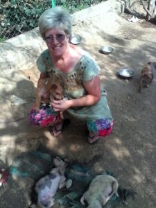 Lee Kaiser with puppies in Nepal