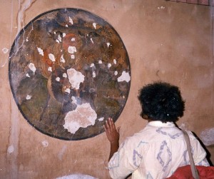 Bullet holes on a Tibetan painting at monastery